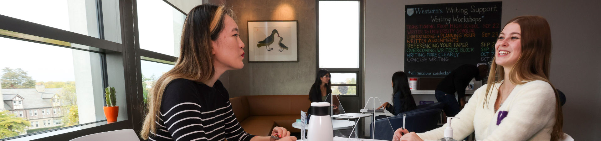 A student receives writing feedback from an advisor.