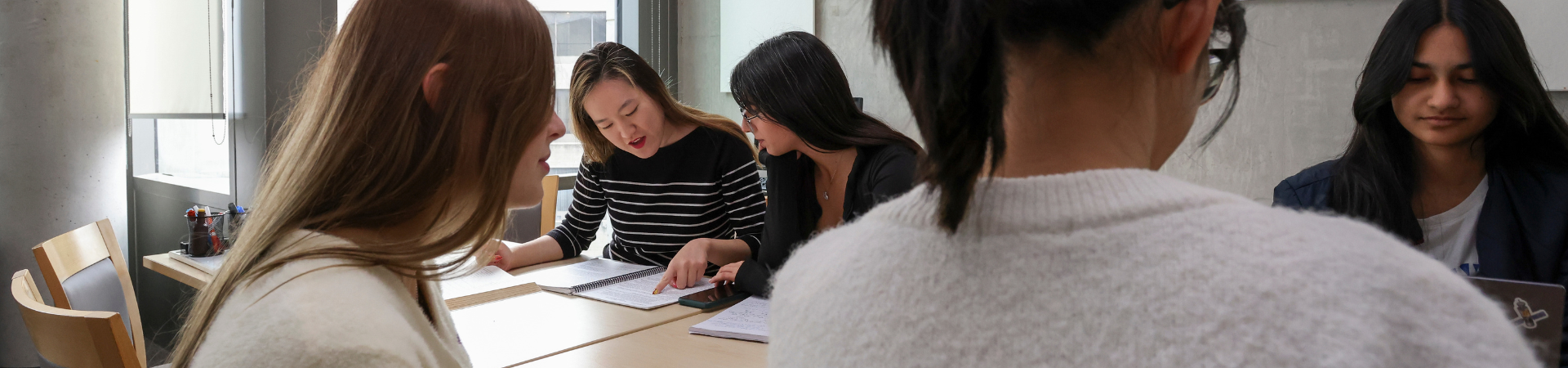 Two people work together at a table.