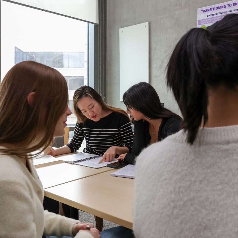 Two people work together at a table.