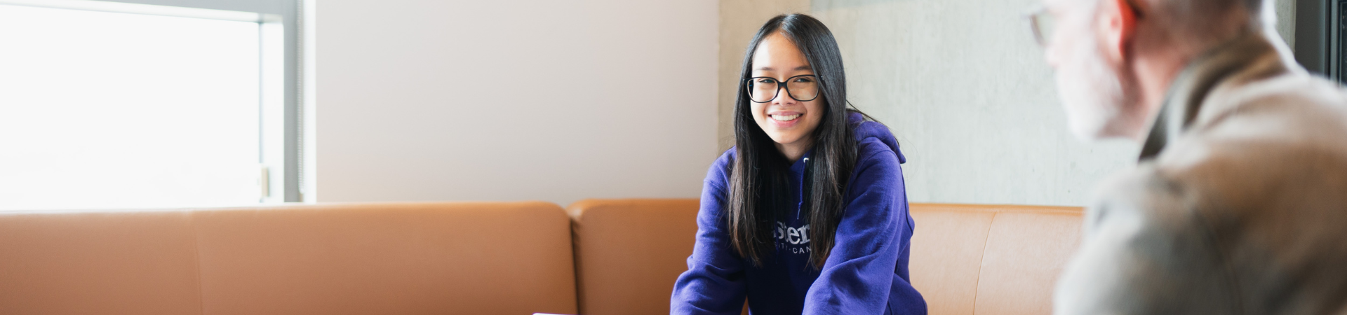 A young woman gets help at the writing centre.